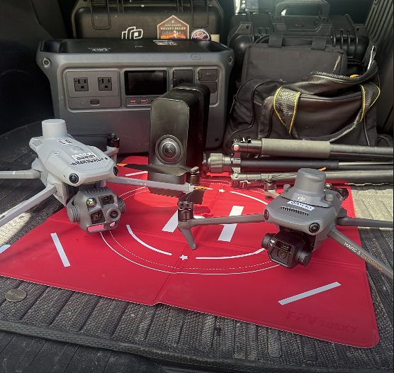 Two enterprise aerial platforms, a Matterport camera and field power equipment on a landing pad