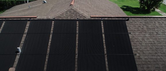 Aerial view of a shingled roof and building exterior